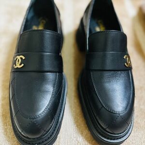 CHANEL Black Loafers with Gold Logo Modern classic. Effortlessly chic.